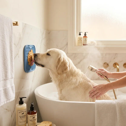 Dog using PawJoy bath lick pad during bath time